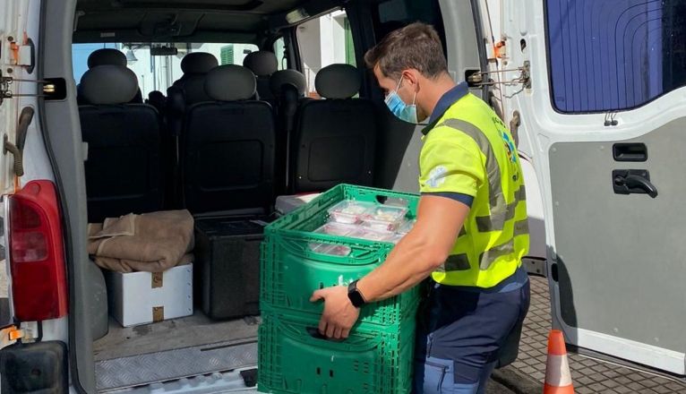 Un voluntario de Emerlan, repartiendo alimentos