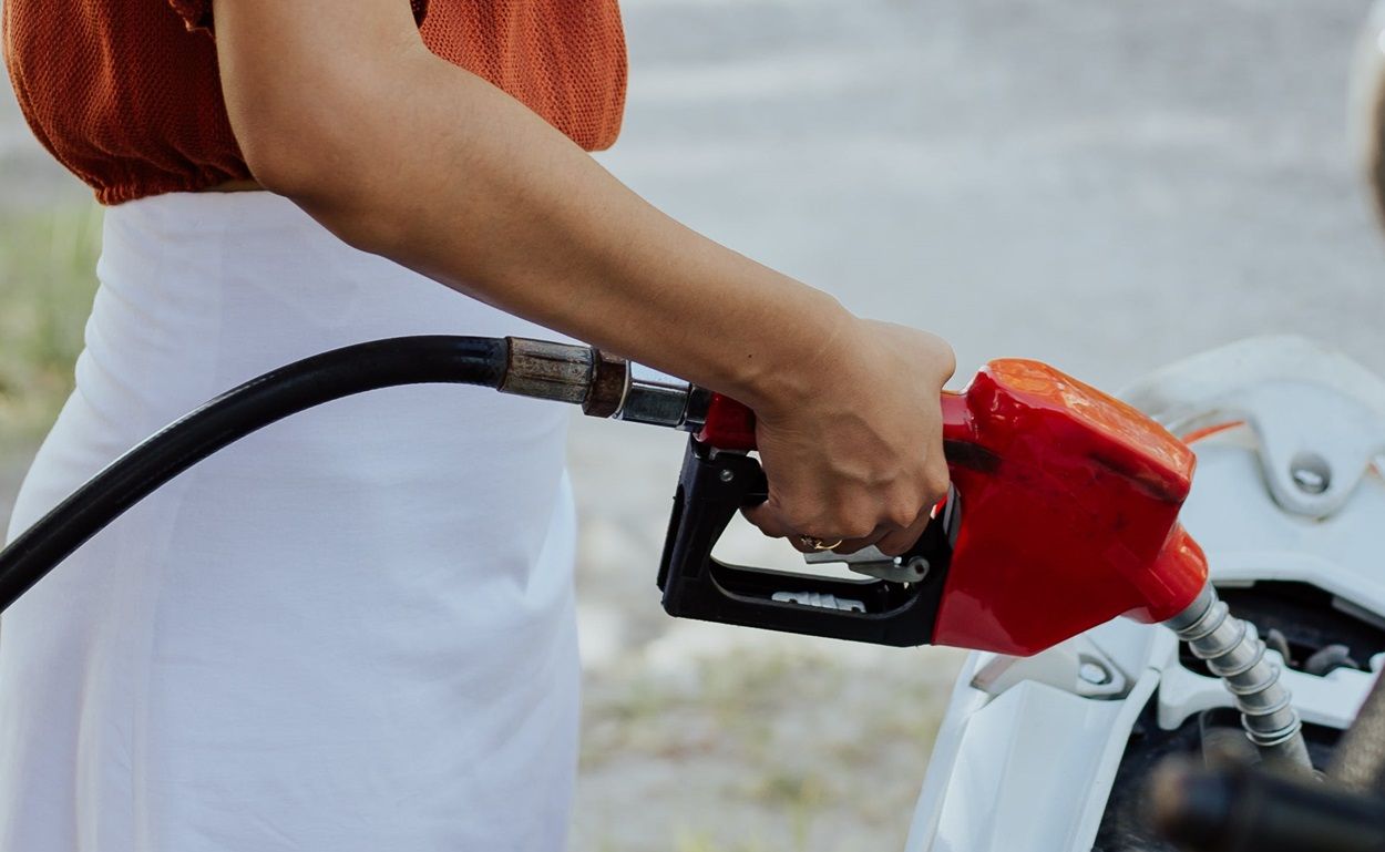 Una mujer repostando combustible